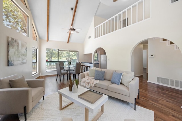 living area featuring visible vents, high vaulted ceiling, wood finished floors, and a ceiling fan