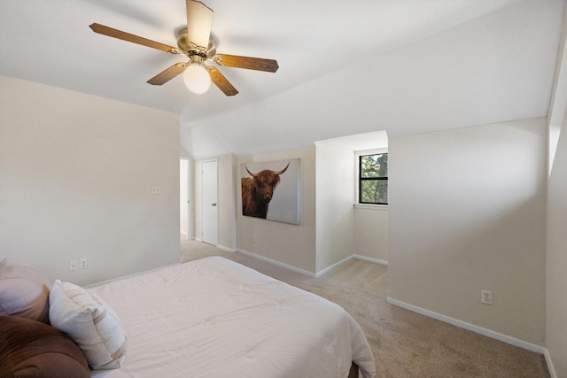 bedroom featuring baseboards, light carpet, ceiling fan, and vaulted ceiling