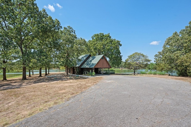 view of front facade featuring an outbuilding, driveway, and a detached garage