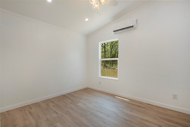 unfurnished room with light hardwood / wood-style flooring, vaulted ceiling, ceiling fan, an AC wall unit, and ornamental molding