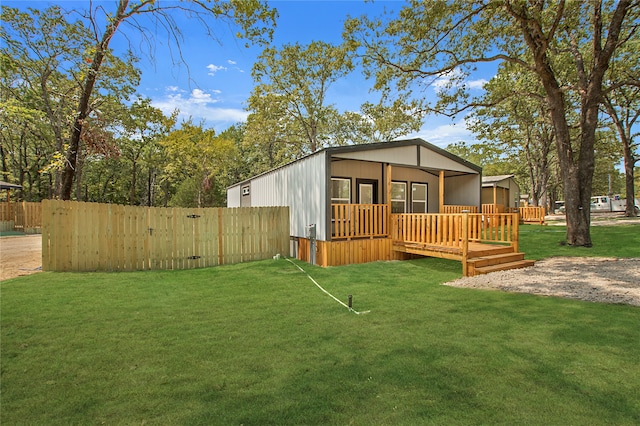 exterior space featuring a lawn and a wooden deck