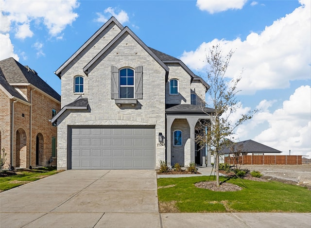 french country inspired facade featuring a garage