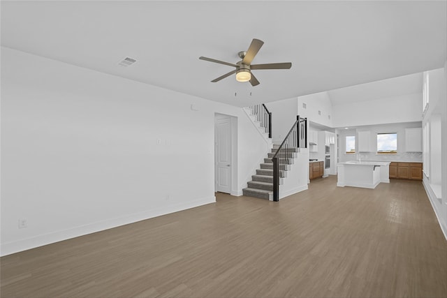 unfurnished living room featuring light hardwood / wood-style floors and ceiling fan