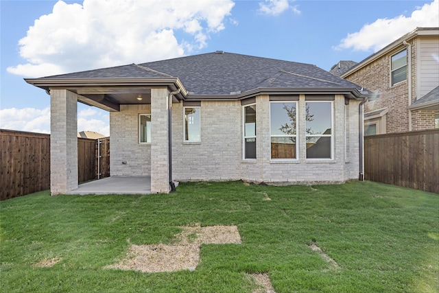 back of house featuring a patio area and a yard