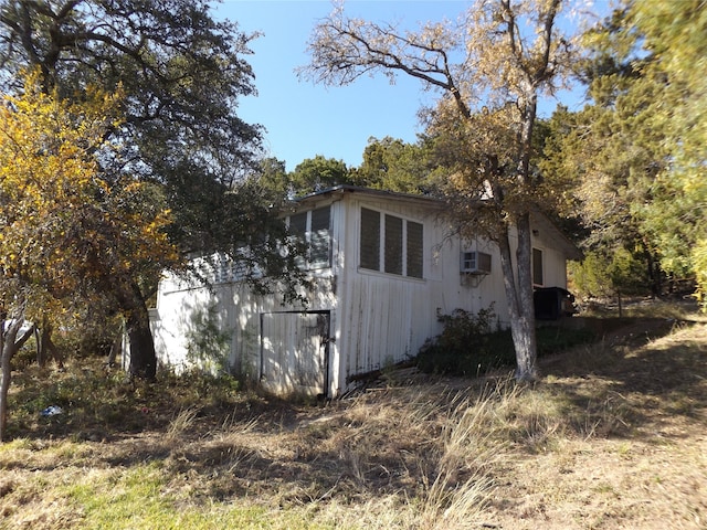 view of property exterior with a wall mounted AC