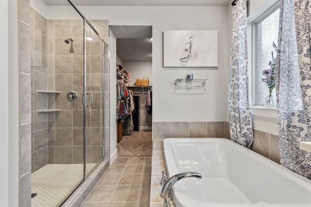 bathroom featuring tile walls, separate shower and tub, and tile patterned floors