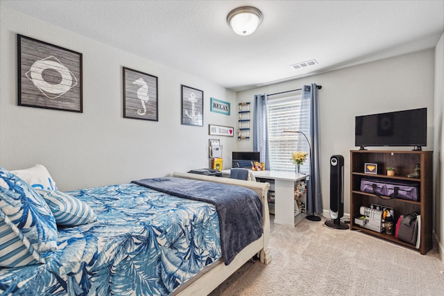 carpeted bedroom featuring a textured ceiling