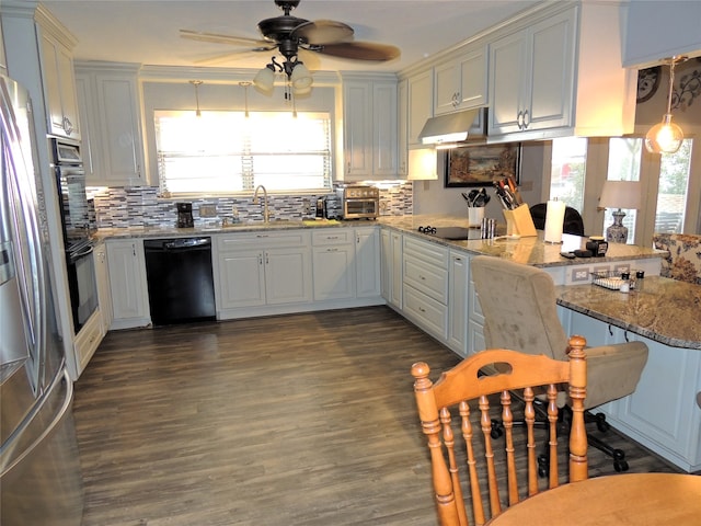 kitchen with dark hardwood / wood-style floors, black appliances, white cabinetry, ceiling fan, and light stone counters