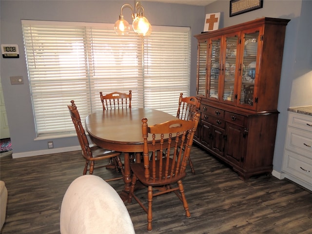 dining room with a notable chandelier and dark hardwood / wood-style flooring