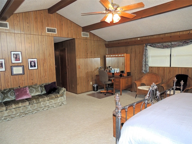 carpeted bedroom featuring wood walls, ceiling fan, lofted ceiling with beams, and a textured ceiling