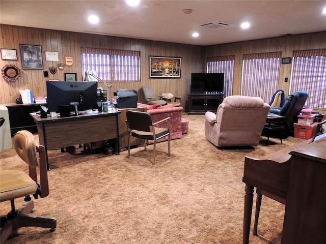 office area featuring carpet and wood walls