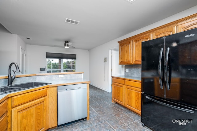 kitchen featuring kitchen peninsula, backsplash, ceiling fan, sink, and black appliances