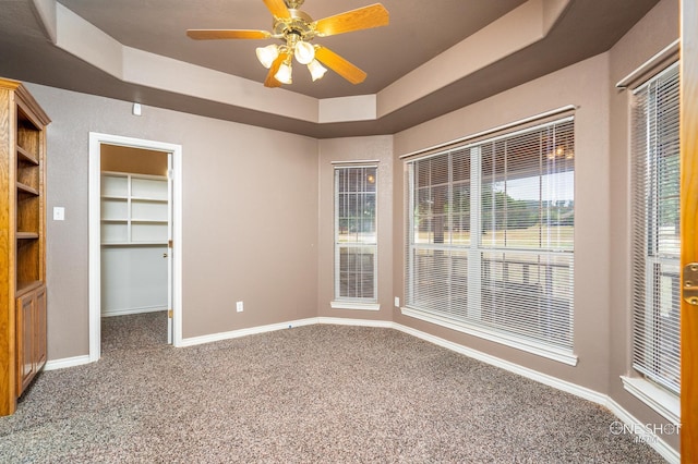 empty room with ceiling fan and a textured ceiling