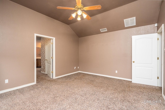 carpeted spare room with ceiling fan, a healthy amount of sunlight, and lofted ceiling