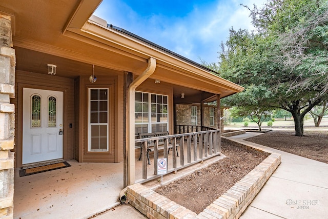 doorway to property featuring covered porch