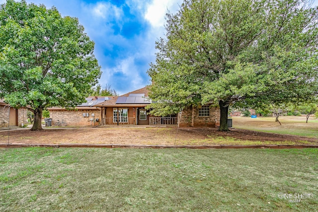 exterior space with a yard and solar panels