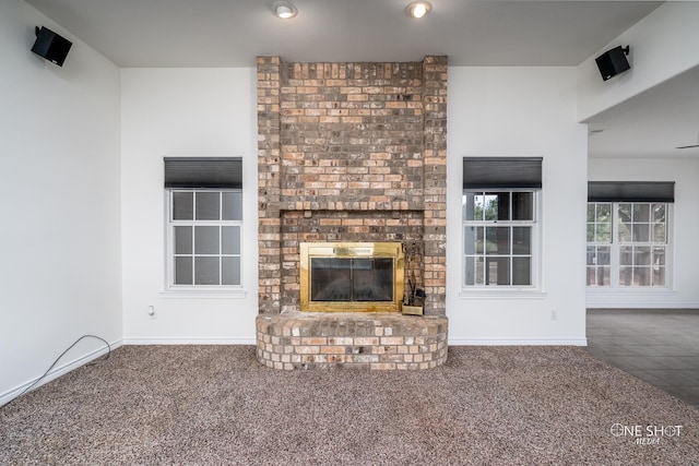 unfurnished living room with a fireplace and carpet