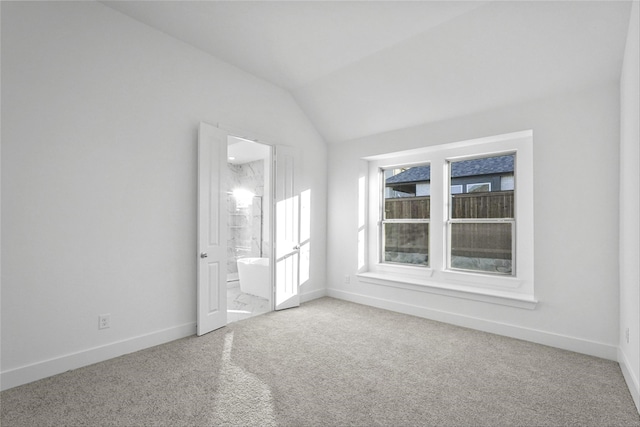 unfurnished room featuring carpet floors and lofted ceiling