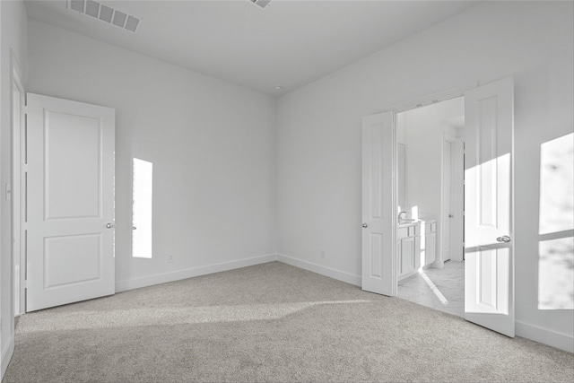 spare room with light carpet