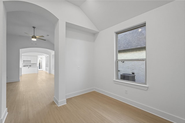 spare room featuring ceiling fan, light hardwood / wood-style flooring, and lofted ceiling