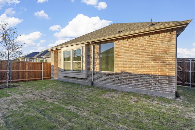 view of side of home featuring a yard