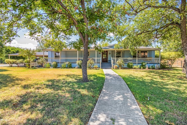 ranch-style house featuring covered porch and a front lawn