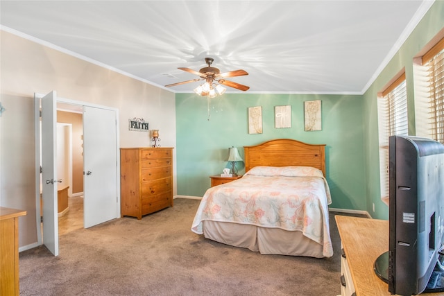 carpeted bedroom with ceiling fan and ornamental molding