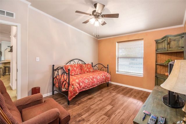 bedroom with ceiling fan, hardwood / wood-style flooring, and ornamental molding