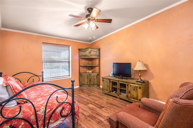 bedroom with crown molding, ceiling fan, and wood-type flooring