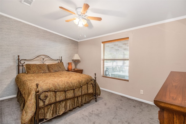 carpeted bedroom featuring crown molding and ceiling fan