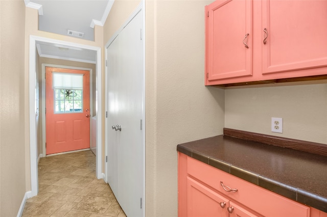 kitchen featuring crown molding and tile countertops