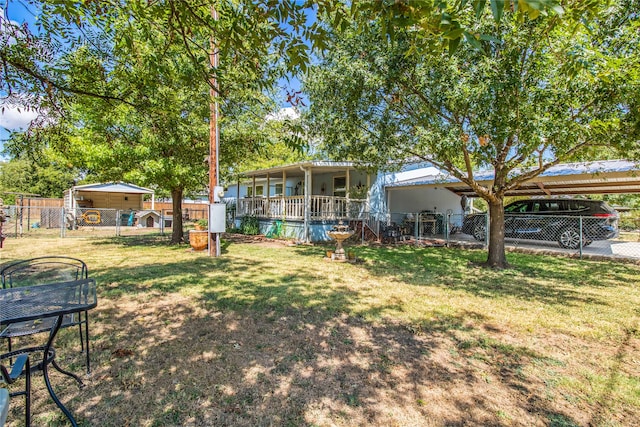 view of yard with a porch and a carport