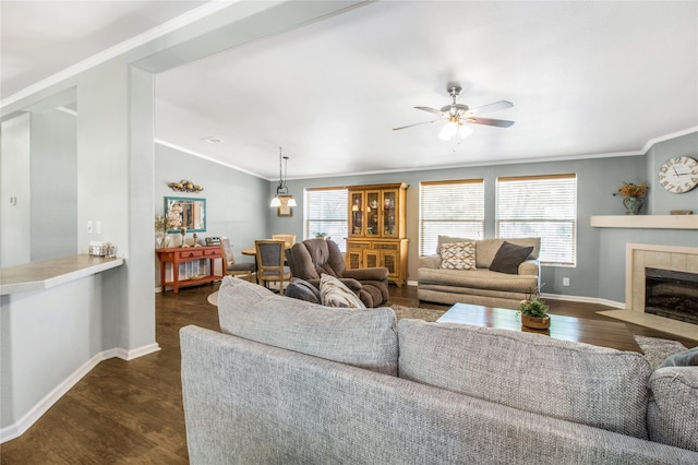 living room with vaulted ceiling, dark hardwood / wood-style flooring, ceiling fan, and a tile fireplace