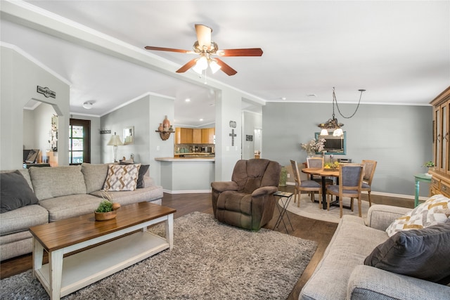 living room featuring ceiling fan, hardwood / wood-style flooring, and crown molding