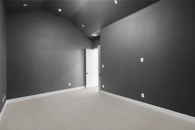 spare room featuring vaulted ceiling