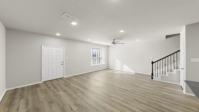 spare room featuring ceiling fan, a textured ceiling, and light hardwood / wood-style flooring