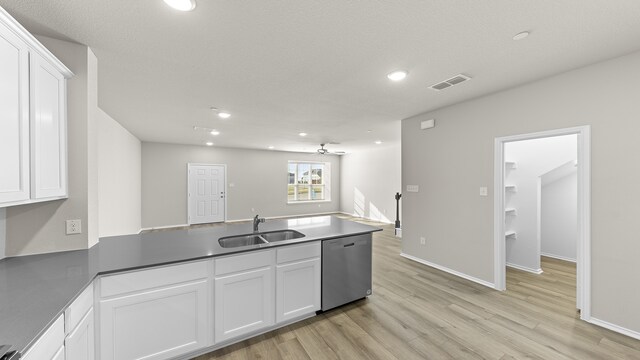 kitchen featuring light wood-type flooring, ceiling fan, sink, dishwasher, and white cabinetry