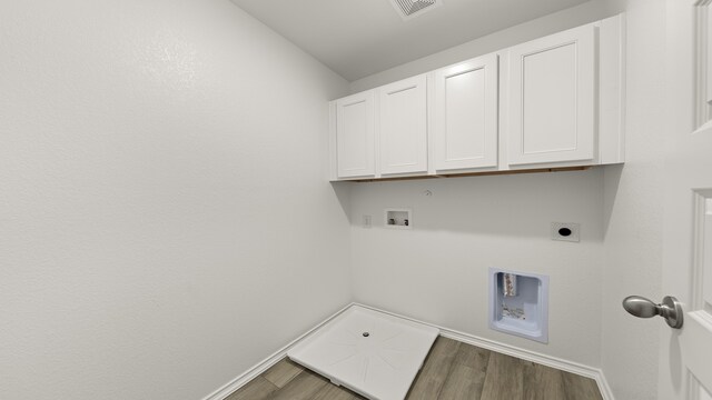 laundry area with washer hookup, wood-type flooring, cabinets, and electric dryer hookup