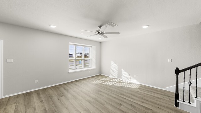 empty room featuring ceiling fan and light wood-type flooring