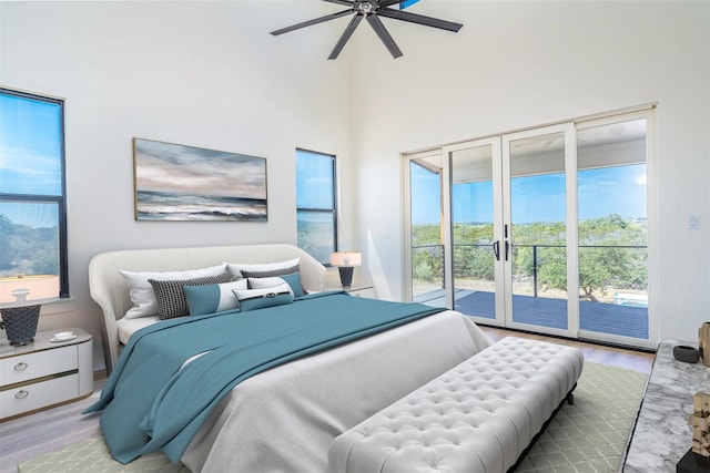 bedroom with access to exterior, ceiling fan, and wood finished floors