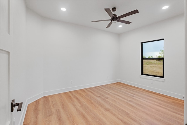 empty room featuring recessed lighting, baseboards, and wood finished floors