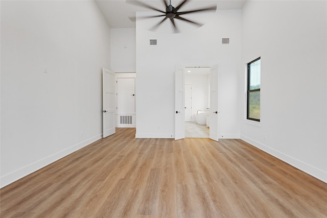 unfurnished bedroom featuring light wood-style floors, visible vents, and baseboards