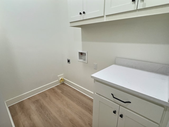 laundry area with hookup for a washing machine, wood finished floors, baseboards, cabinet space, and electric dryer hookup