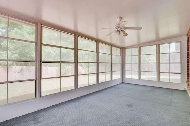 unfurnished sunroom with ceiling fan