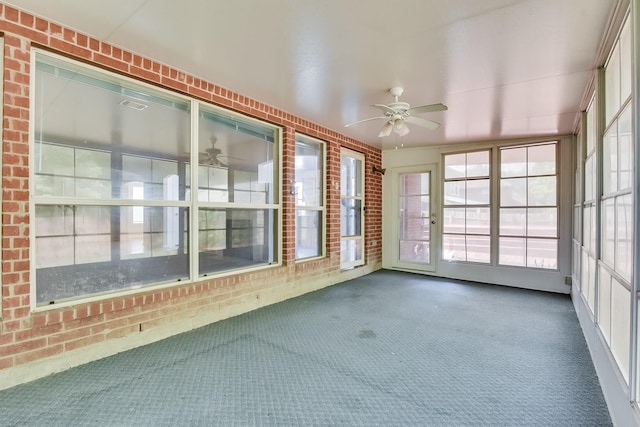 unfurnished sunroom with ceiling fan