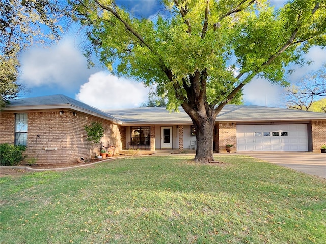 ranch-style house featuring a garage and a front yard