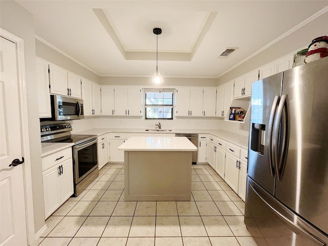 kitchen featuring a raised ceiling, a center island, stainless steel appliances, sink, and white cabinets