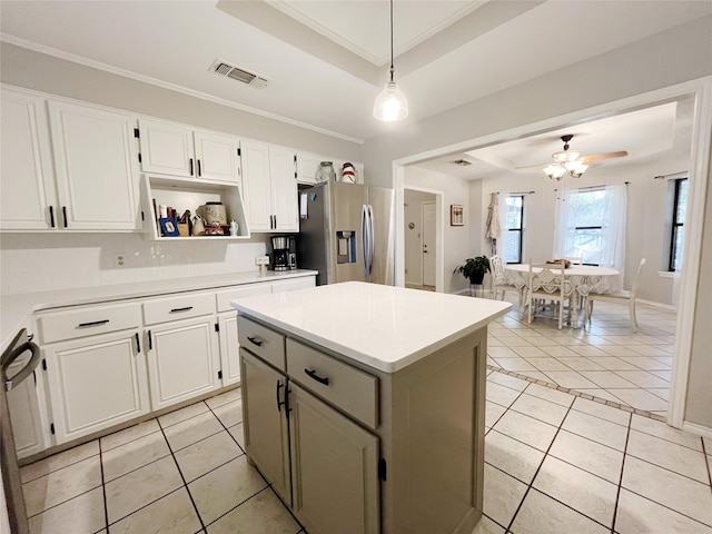 kitchen with decorative light fixtures, appliances with stainless steel finishes, white cabinetry, ceiling fan, and ornamental molding