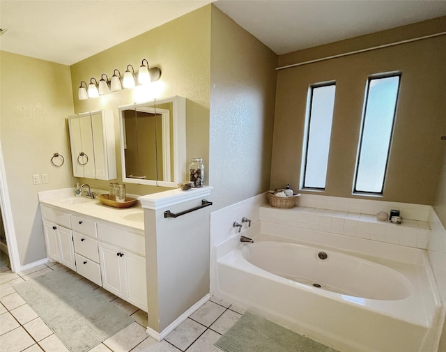 bathroom with tile patterned floors, vanity, a bathing tub, and a healthy amount of sunlight