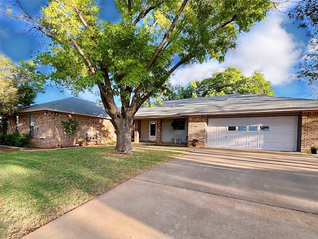 ranch-style home featuring a garage and a front lawn